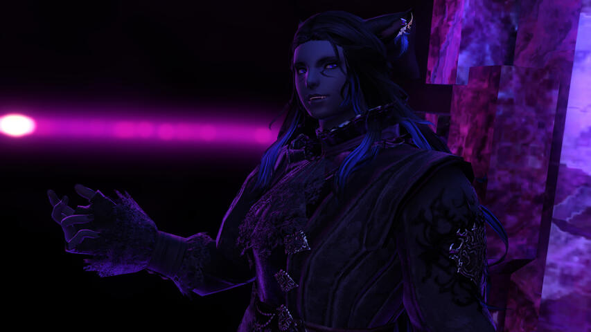 Untitled Same screenshot as is on the initial home page, but with a wider crop. He is standing against purple crystal and gesturing with his right arm.